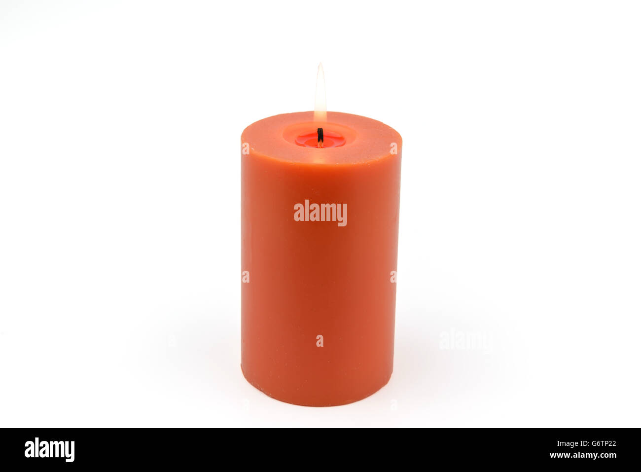 Buring Aromatic candle, orange color round shape Stock Photo