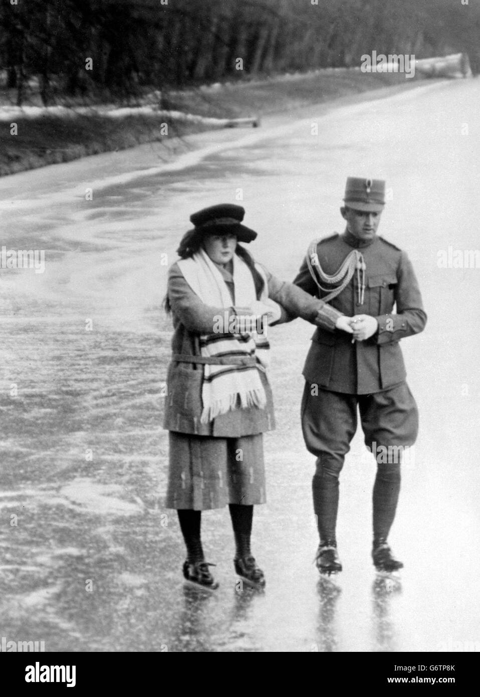 Princess Juliana - the daughter of Queen Wilhelmina - skating on the ice behind the Royal Palace at the Hague with one of the Queen of Holland's adjutants. Stock Photo