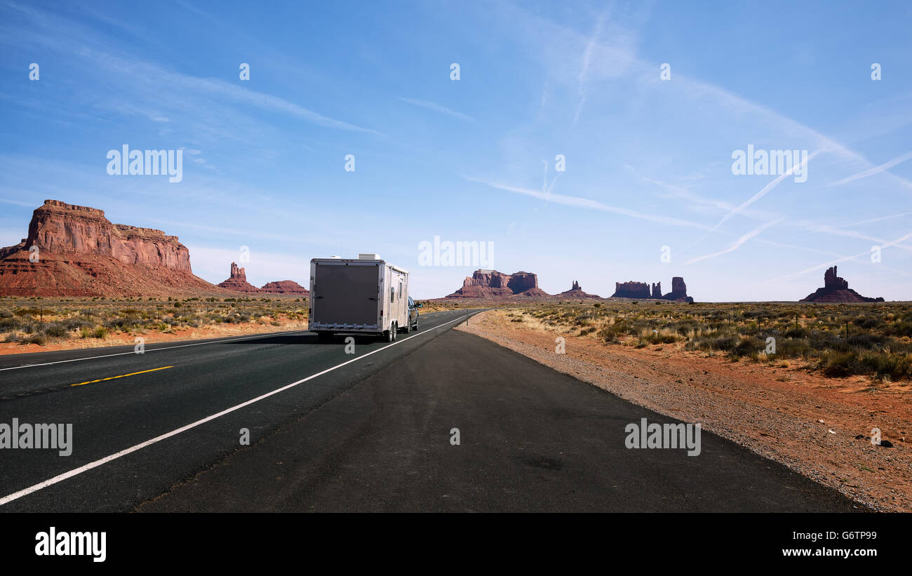 RV commuting on scenic road. The mittens, Mesa, red rock at Monument Valley, Navajo Tribal Park, Arizona USA Stock Photo