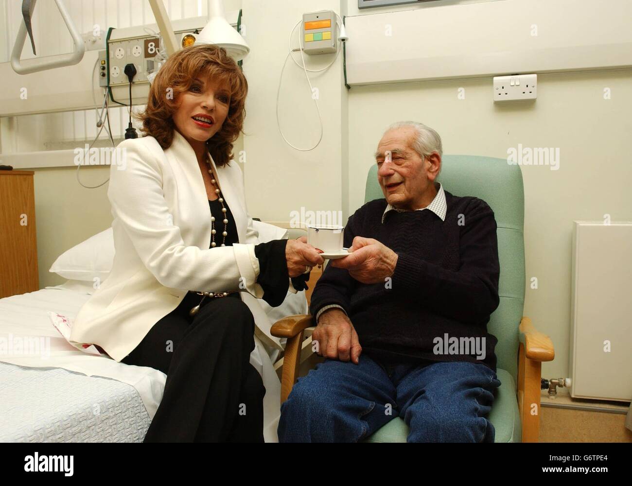 Actress Joan Collins takes on the role of tea lady and serves tea to a cancer patient at the Royal Marsden Hospital in Kensington, west London to help support the hospital's 30 million Royal Marsden Cancer campaign. Stock Photo