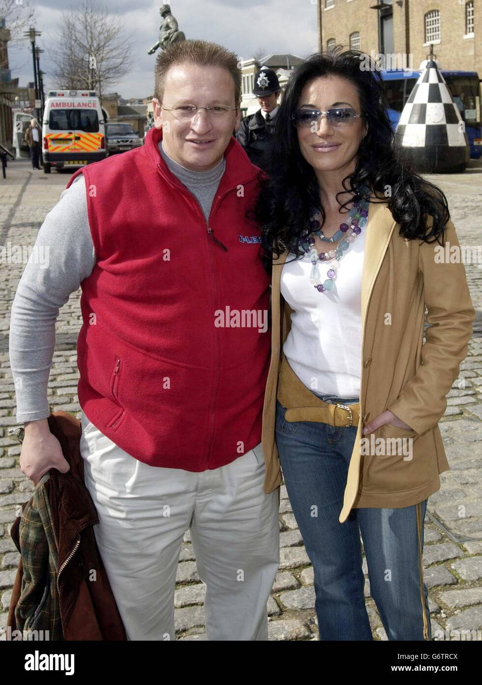 Nancy Dell'Olio with the former Chief Executive of the Millennium Dome Pierre-Yves Gerbeau as they arrive to join 600 city workers and school children as they attempt to break the Guinness World Record for the most people bouncing on space hoppers for one minute, at the London Docklands. The event also aims to raise awareness and funds for the Cystic Fibrosis Trust. Stock Photo