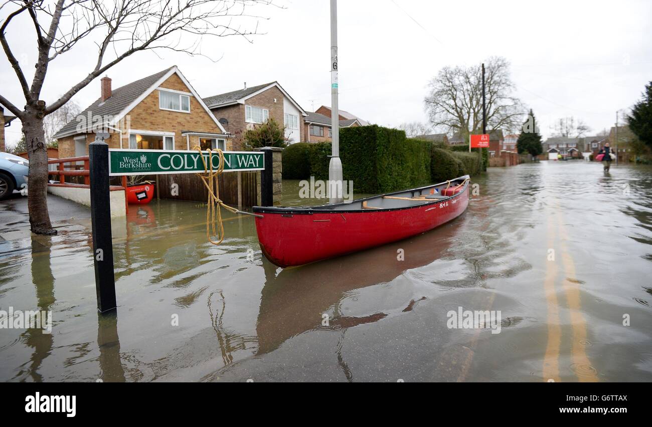 A kayak is tied up on a flooded street in Purley on Thames waiting to be used to ferry residents to and from their houses. Stock Photo