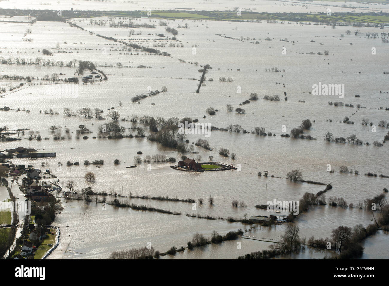 Water surrounds flooded properties in the Village of Moorland on the