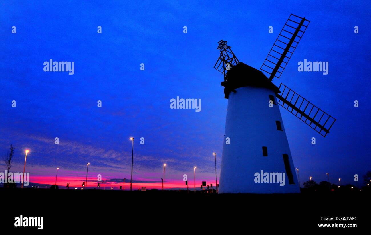 The sun rises behind the Grade Two listed Lytham windmill in, Blackpool, Lanchashire. Stock Photo
