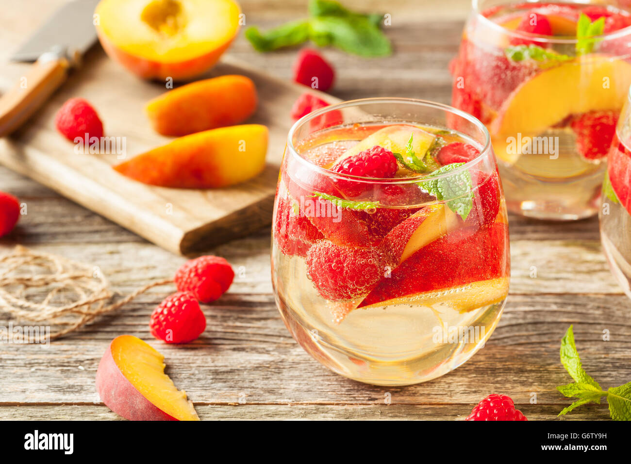 Homemade Sparkling White Wine Sangria with Peaches and Raspberries