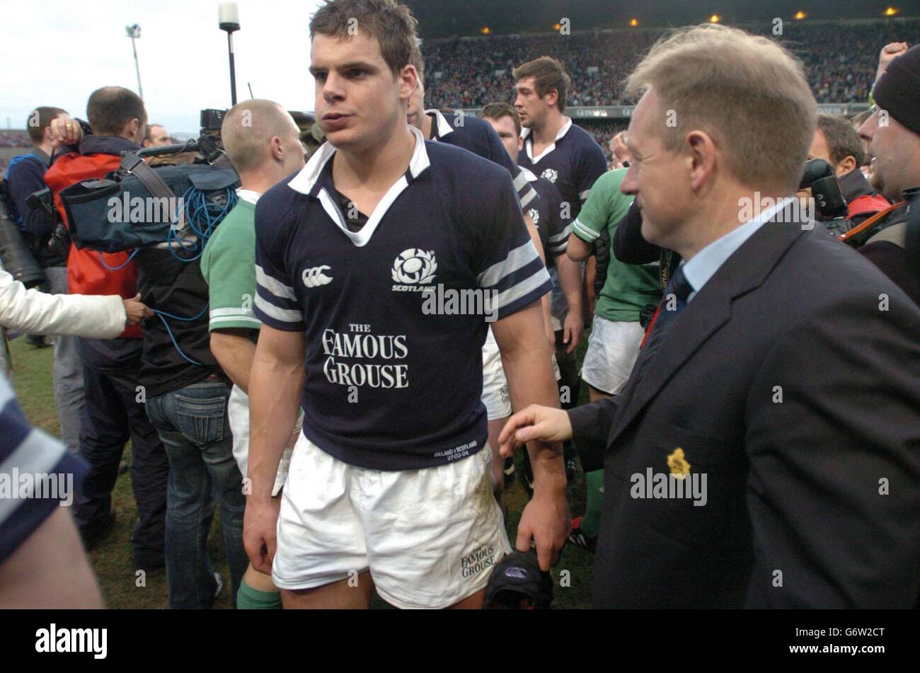 Scotland centre Tom Philip as he leaves the pitch, passing Ireland coach, Eddie O'Sullivan (R), after the Ireland v Scotland RBS 6 Nations match at Lansdowne Road, Saturday, 27 March, 2004. Stock Photo