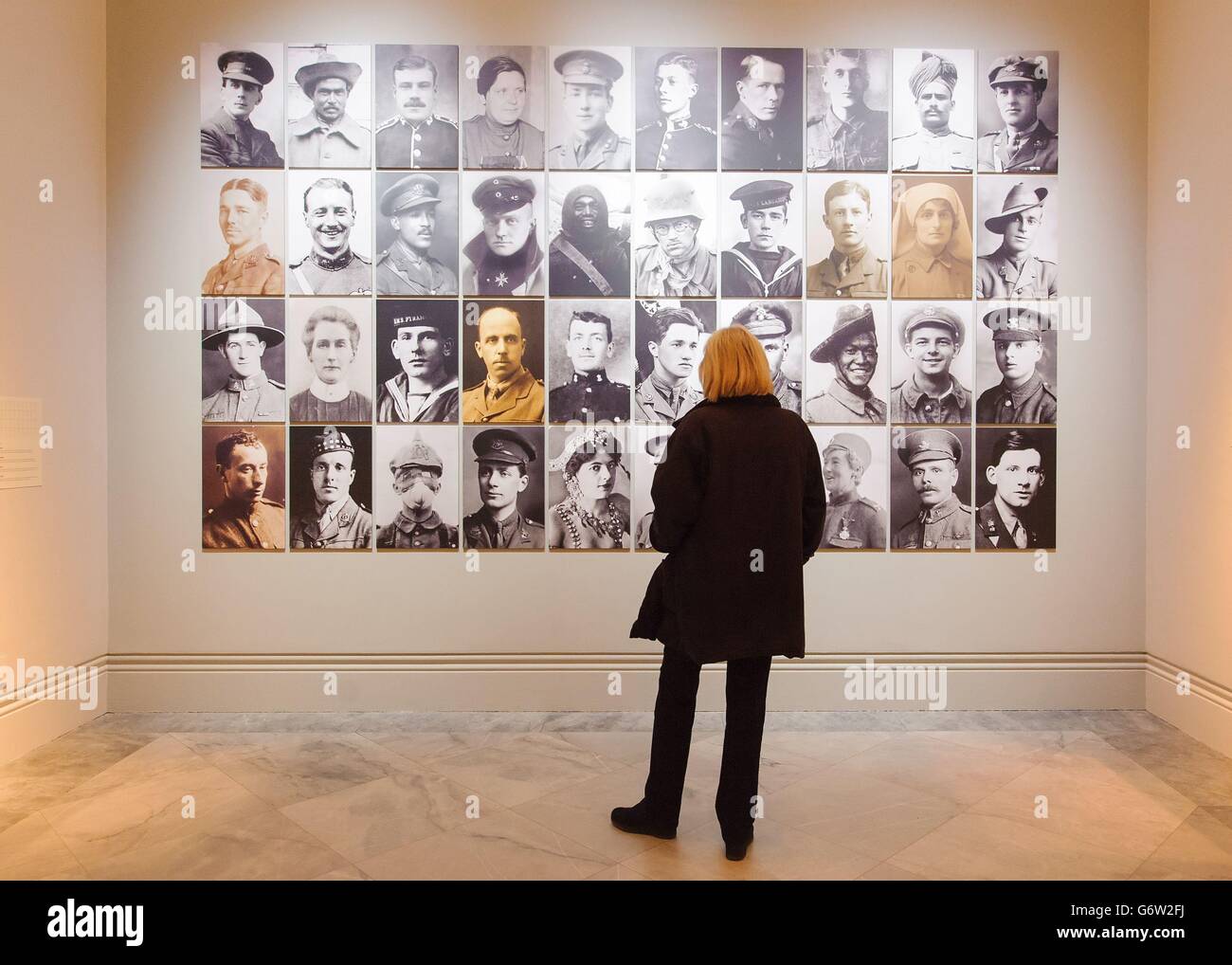 A visitor views a montage of portraits of protagonists of World War I, which is part of 'The Great War in Portraits' exhibition, which runs at the National Portrait Gallery, in central London, from February 27 to June 15, 2014. Stock Photo