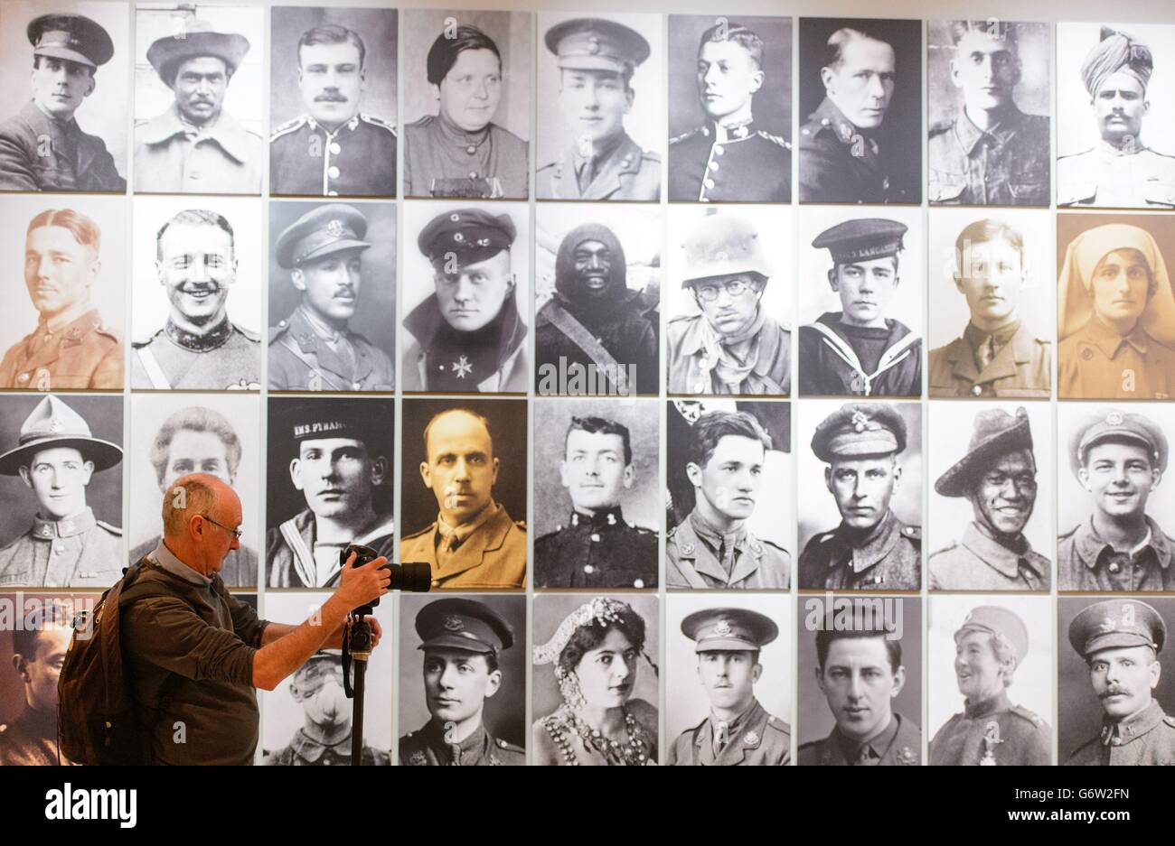 A visitor views a montage of portraits of protagonists of World War I, which is part of 'The Great War in Portraits' exhibition, which runs at the National Portrait Gallery, in central London, from February 27 to June 15, 2014. Stock Photo