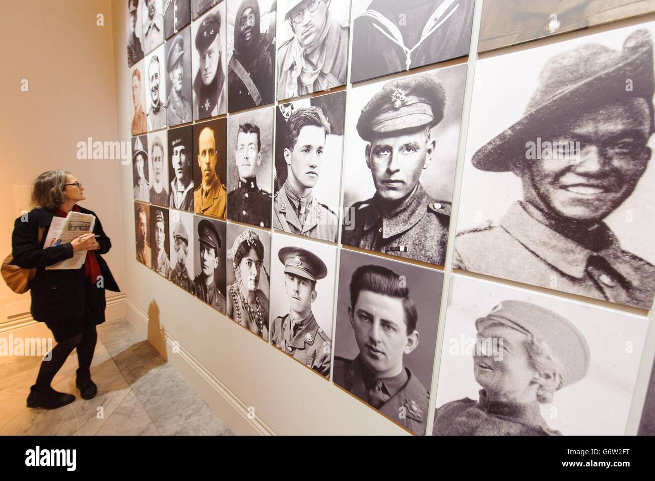 A visitor views a montage of portraits of protagonists of World War I, which is part of 'The Great War in Portraits' exhibition, which runs at the National Portrait Gallery, in central London, from February 27 to June 15, 2014. Stock Photo