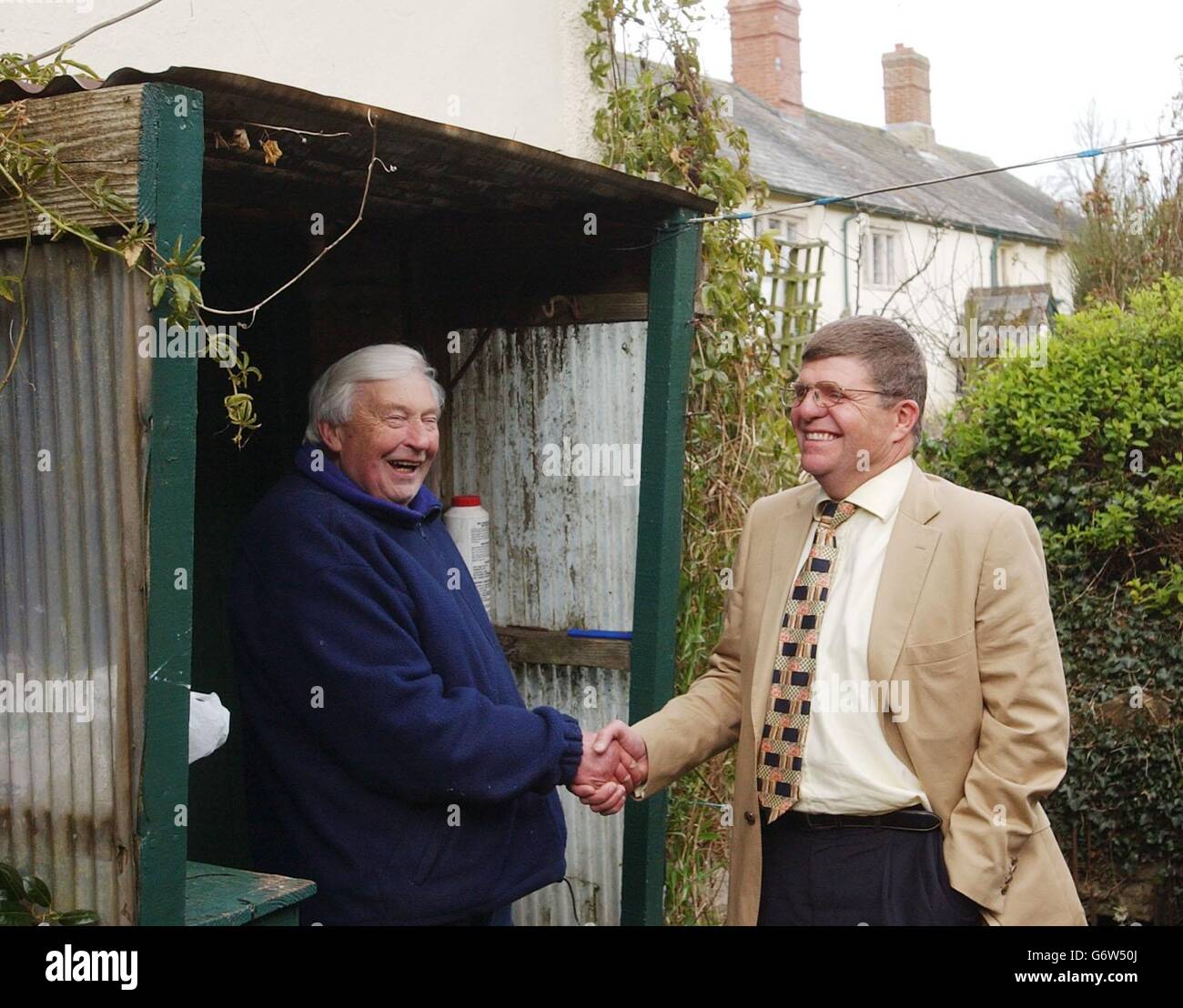 Canadian-born estate owner Richard Marker, 50, (right) shakes the hand of life-long village resident Sidney Phillips, 71, after a buyer was found for the village properties. Fifteen homes in Gittisham, East Devon, will be sold to Northumberland and Durham Property Trust. A further nine houses will be sold to tenants. Stock Photo