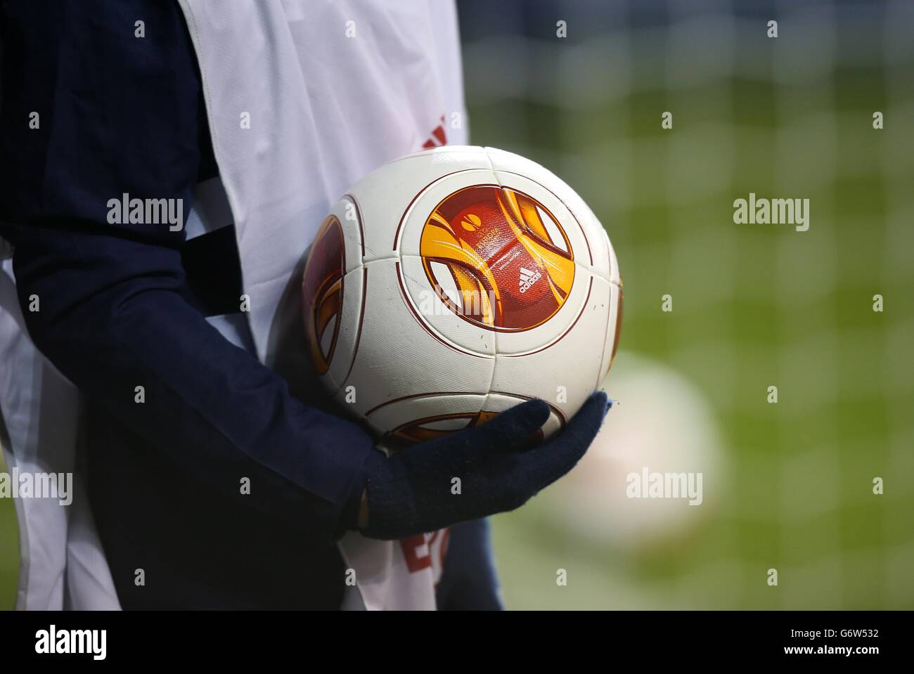 A ball boy carries out the official match ball before the game Stock Photo