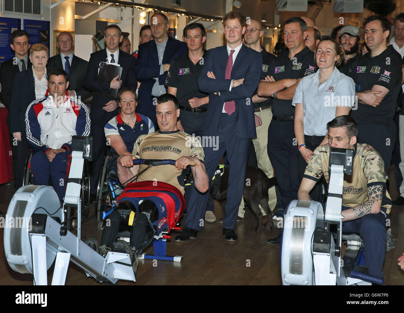 Prince Harry (centre) watches as members of the Row2Recovery crew race