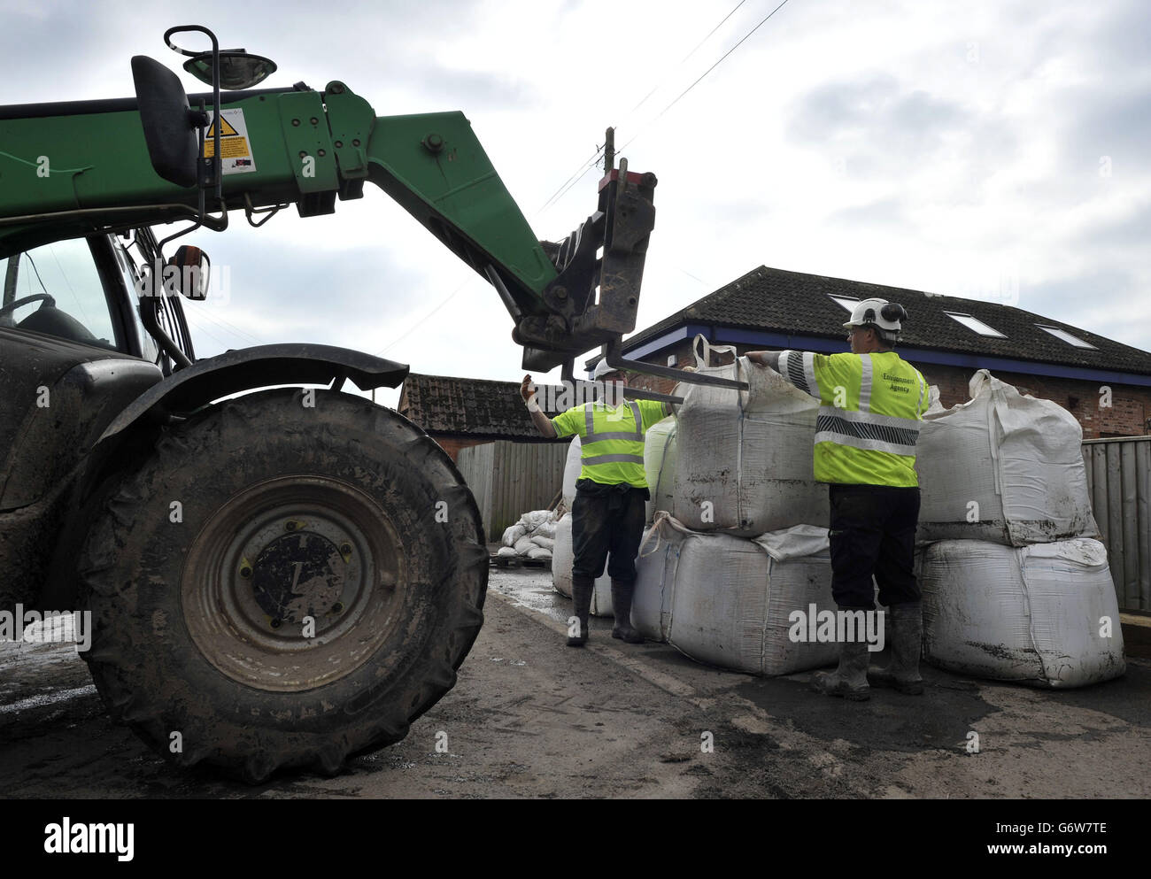 Sandbags used for flood protection are removed from the village of Moorland, Somerset, as the process of clearing the flood damage has begun as the water levels recede. Stock Photo