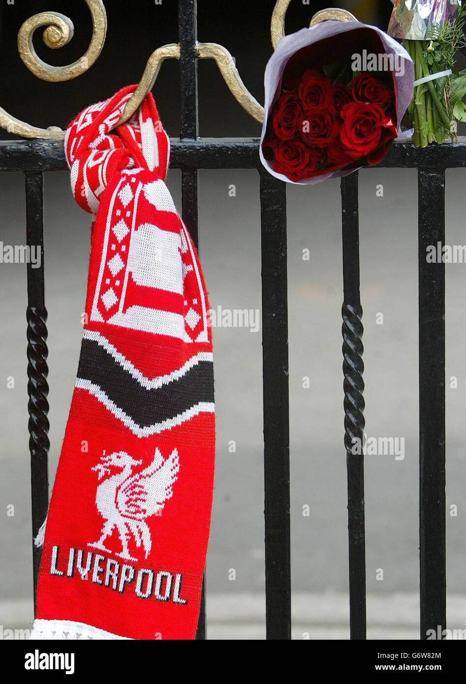A Liverpool scarf is tied to the Shankly gates of Liverpool Football Club's Anfield stadium, on the 15th anniversary of the Hillsborough disaster. Where a memorial service was taking place at the Kop stand. A candle will be lit for each of the 96 victims who were crushed to death on the Leppings Lane terrace of Sheffield Wednesday's Hillsborough ground during Liverpool's 1989 FA Cup semi-final clash. Stock Photo