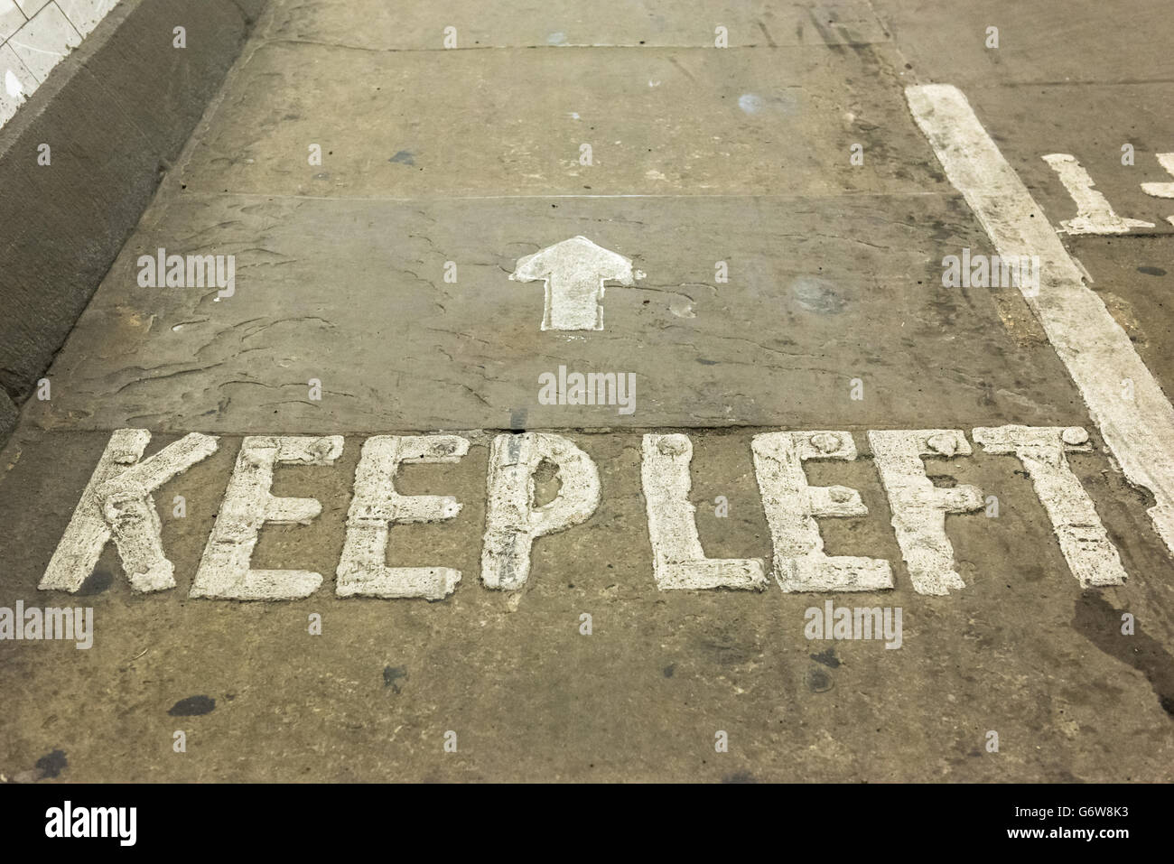 Keep left sign written on floor of Greenwich Tunnel in London, United Kingdom Stock Photo