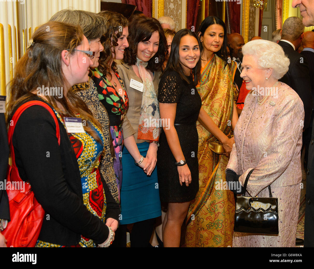 Queen Elizabeth II (right) meets members of the Commonwealth Secretariat at the Commonwealth Reception, at Marlborough House in central London. Stock Photo