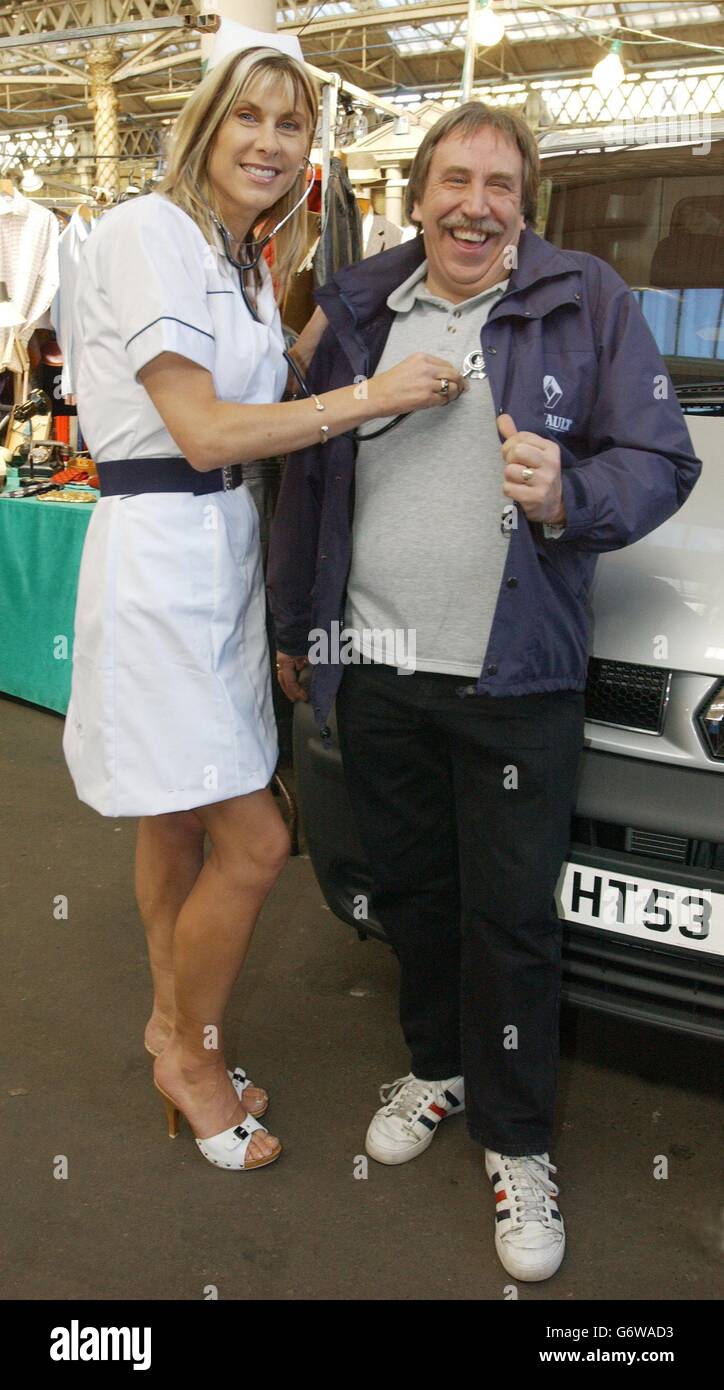 Former Olympic swimmer Sharron Davies in London's Spitalfields Market, checking the heart beat of van driver Les Barnes during the launch of the Renault Vandurance Roadshow, which will be providing free professional health and eyesight checks for van drivers when it travels Britain this summer after the car makers recently sponsored a nationwide survey which found that van drivers do not tend to take enough care of their health. Stock Photo