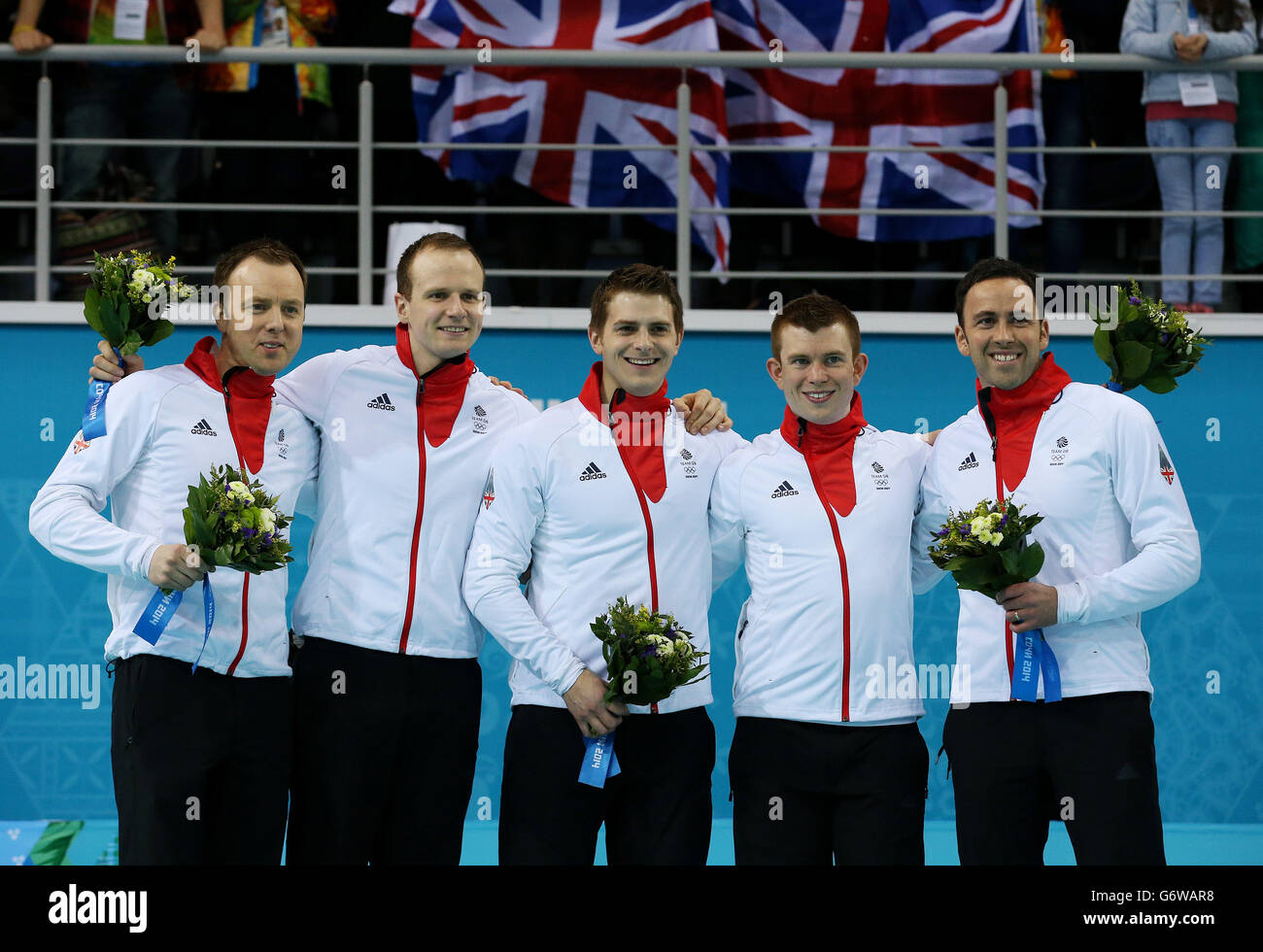 Great Britain's (left to right) Tom Brewster, Michael Goodfellow, Scott Andrews, Greg Drummond and David Murdoch during the flower ceremony after taking Silver in the Men's Gold medal match at the Ice Cube Curling Centre during the 2014 Sochi Olympic Games in Sochi, Russia. Stock Photo