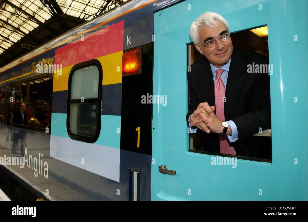 Transport Minister Alistair Darling leans out of a first class carriage on the new Raewald train that he officially unveiled at Liverpool Street Station, London. The train is part of a new franchise combining services from the old Anglia, Great Eastern and West Anglia routes, including the Stansted Express and provides services from London's Liverpool Street station to Hertford, Cambridge, Peterborough, Southend and throughout Essex and to Norwich and east coast resorts. Stock Photo