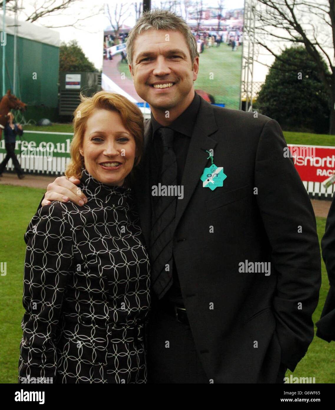 Former footballer Alan Miller and former Emmerdale star Malandra Burrows at Aintree racecourse. Stock Photo