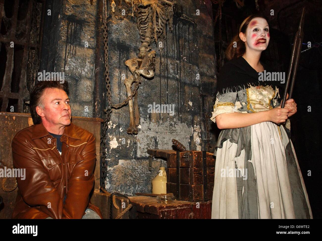 Singer Paul Young is shown a demonstration of an tongue extraction instrument at the London Dungeon, central London, during the launch of the new 1 million pound spine-chilling attraction Traitor: Boat Ride To Hell. Stock Photo