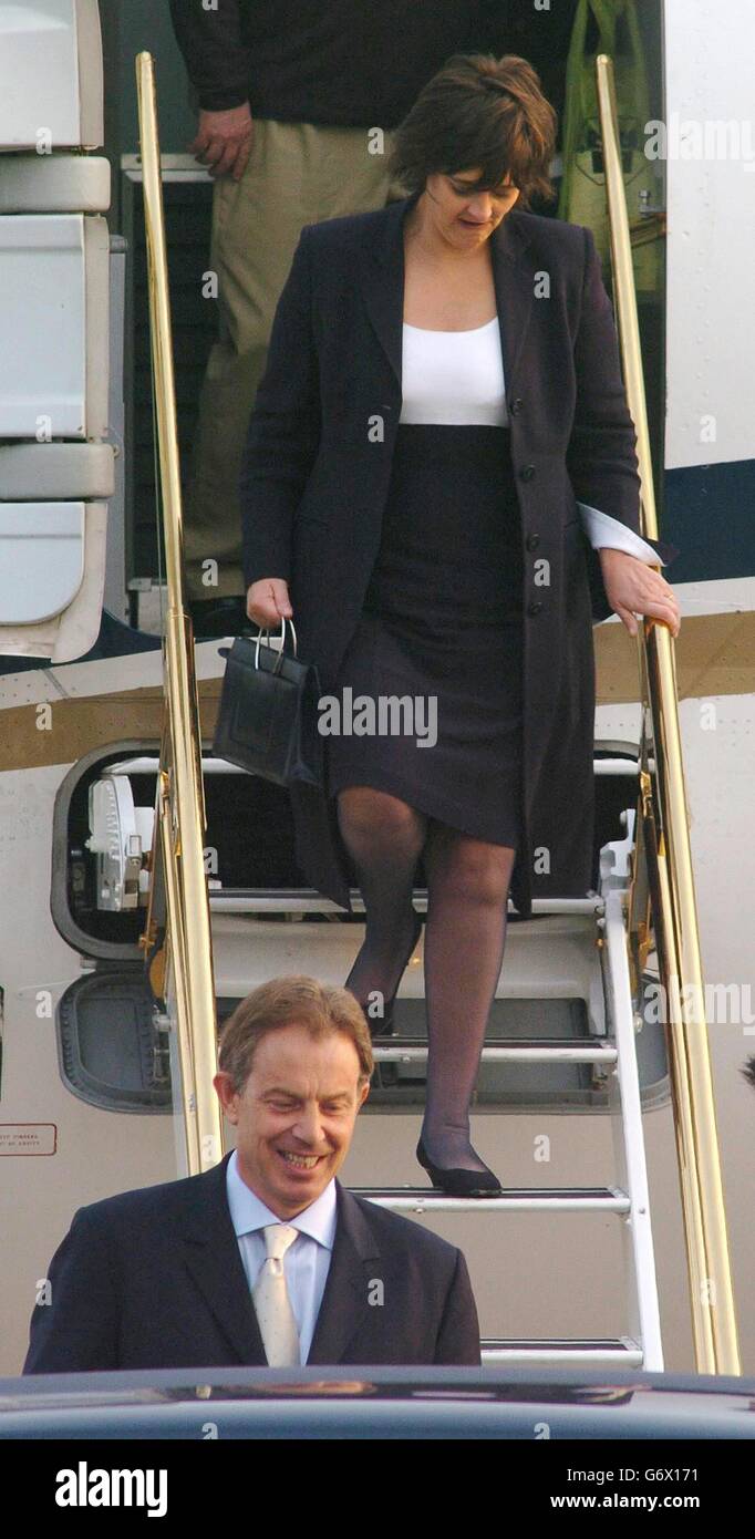 Prime Minister Tony Blair and his wife Cherie arrive at Heathrow Airport, after his meeting with President Bush in Washington. Mr Blair today said the battle lines are clear in Iraq and told critics 'there is only one side to be on'. He was speaking after crisis talks in Washington which ended with him and US President George Bush vowing to defeat insurgents. Stock Photo