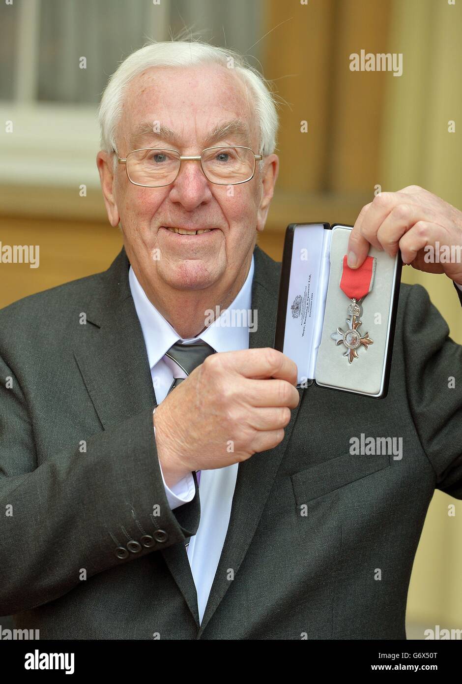 Mr proudly holds his MBE (Member of the British Empire