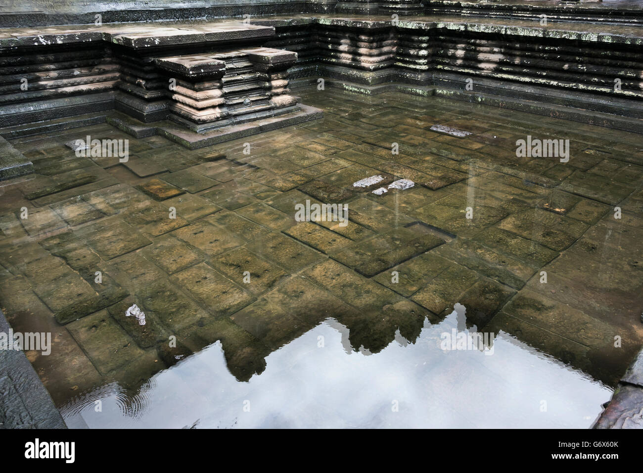 Reflection of Angkor Wat in a rain pool in an upper level courtyard