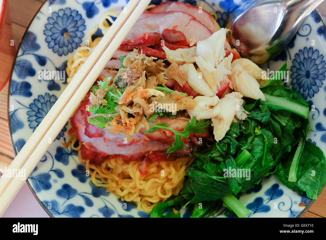 egg noodles with roasted red pork with crab meat and pak choy. Famous Local Thai style street food. Stock Photo