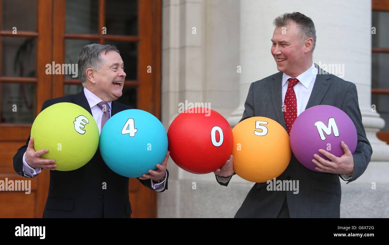 Minister for Public Expenditure and Reform, Brendan Howlin (left) and National Lottery boss Dermot Griffin during a photocall at Government Buildings, Dublin, as Premier Lotteries Ireland has been awarded the next licence to operate the National Lottery. Stock Photo