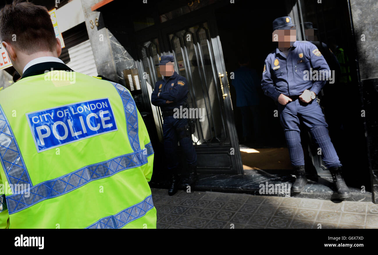 NOTE: IMAGE PIXELATED AT THE REQUEST OF THE POLICE Officers from City of London Police and their Spanish counterparts from the Policia Nacional raid a business property in Barcelona, Spain, to execute a warrant in a joint operation as they target a boiler room investment fraud operation. Stock Photo