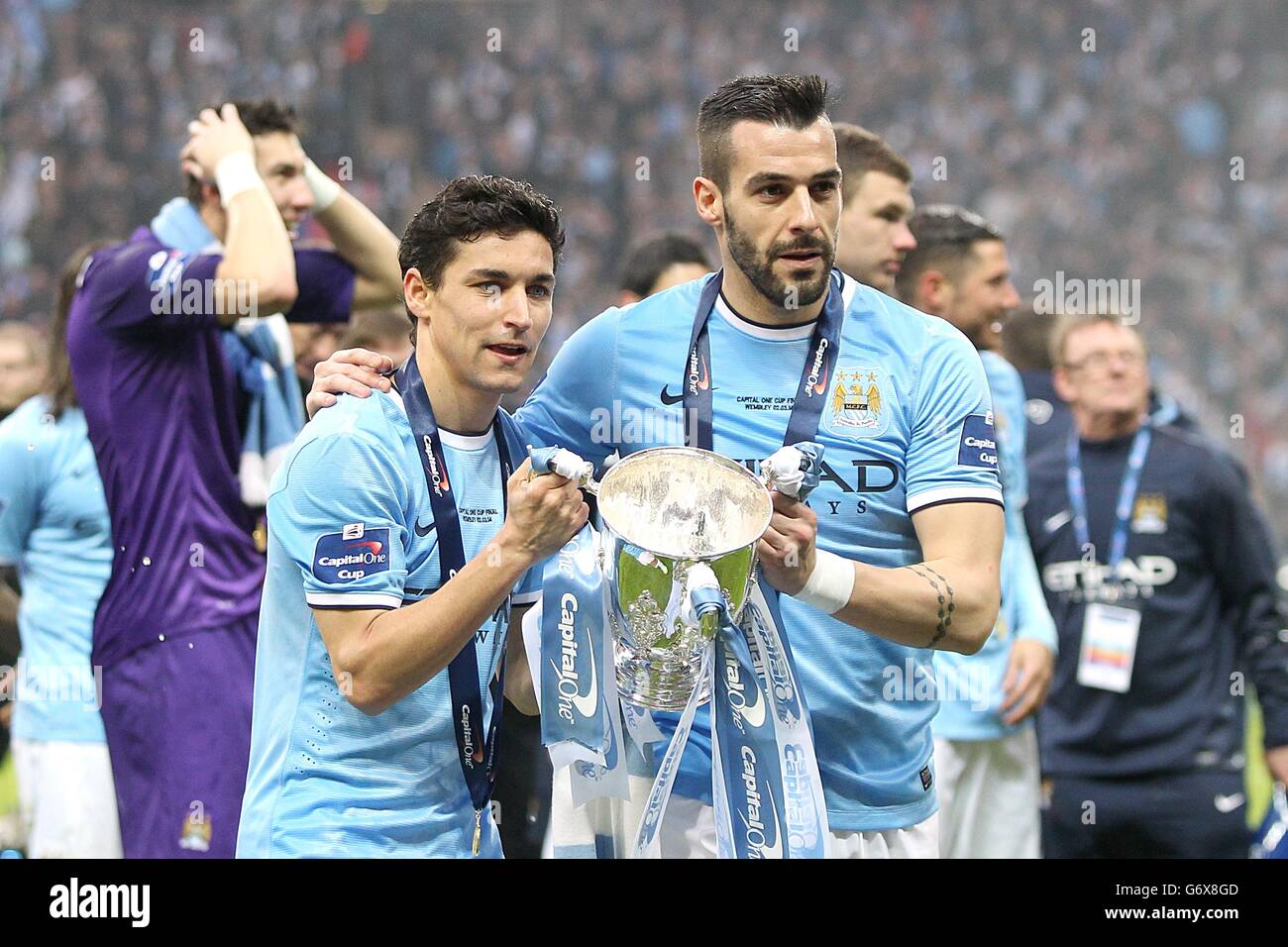 Manchester City's Gonzalez Jesus Navas and Alvaro Negredo (right) celebrate with the Capital One Cup trophy following victory over Sunderland Stock Photo