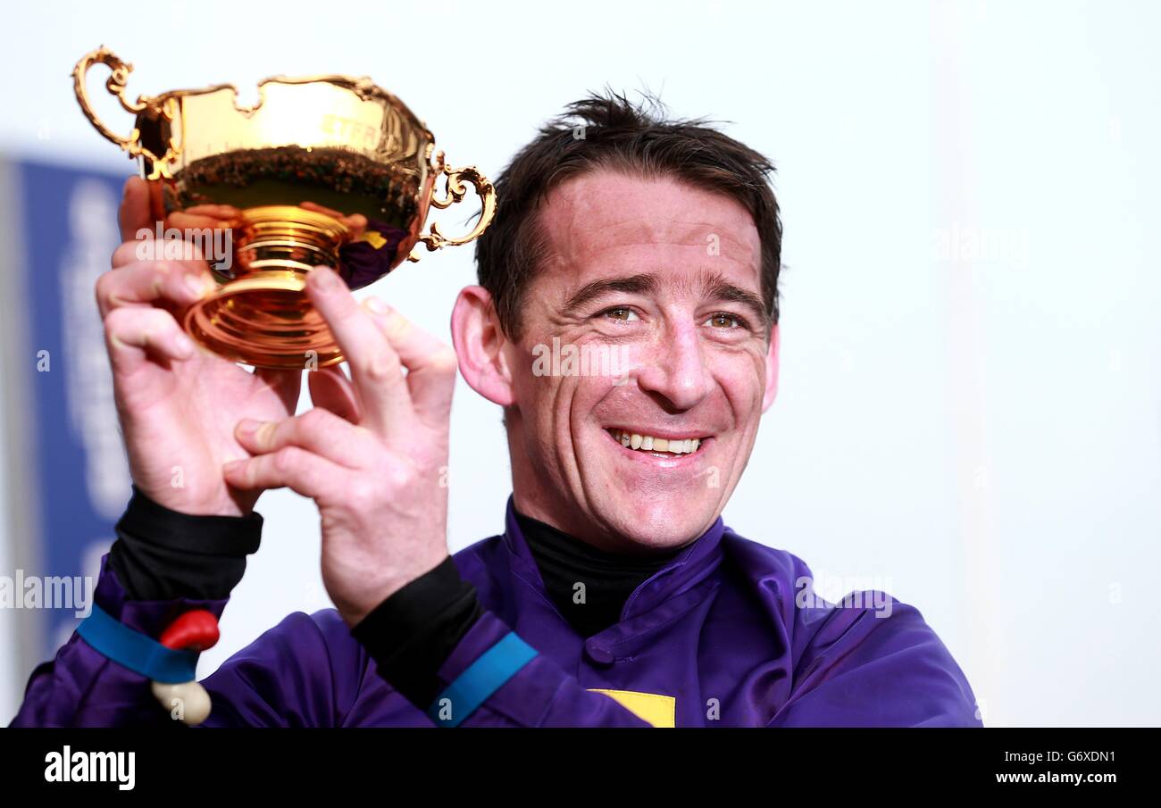 Jockey Davy Russell celebrates with the Gold Cup trophy after winning the Betfred Cheltenham Gold Cup Chase on board Lord Windermere on Gold Cup Day, during the Cheltenham Festival. Stock Photo