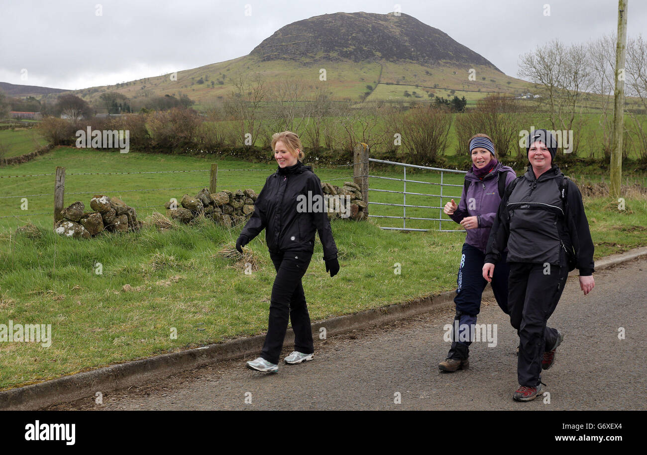 People complete the annual St Patrick's Day climb of Slemish mountain in Co Antrim. Stock Photo