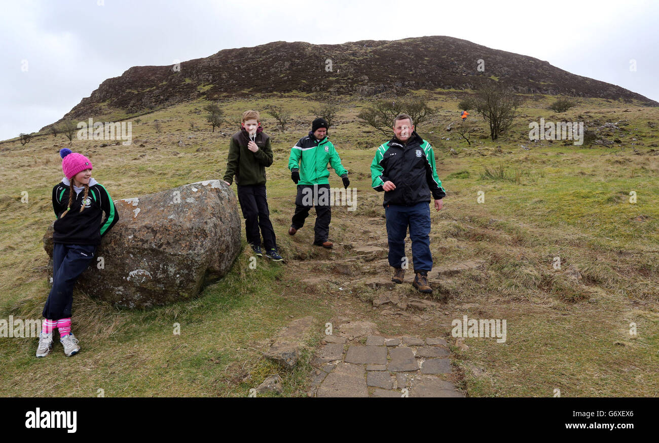 People complete the annual St Patrick's Day climb of Slemish mountain in Co Antrim. Stock Photo