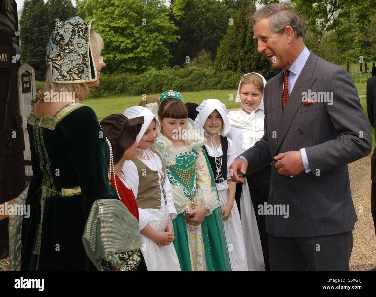 The Prince of Wales meets local school children at an exhibition inside a timber framed barn dating back to the 13th century, at Cressing Temple in Essex, during his visit to the Cressing Estate. The site comprises of ancient barns and buildings and was restored in 1987 by the county council. The Royal visitor was there in 1991 but returns today to see extra work including the development of a Tudor garden. Stock Photo