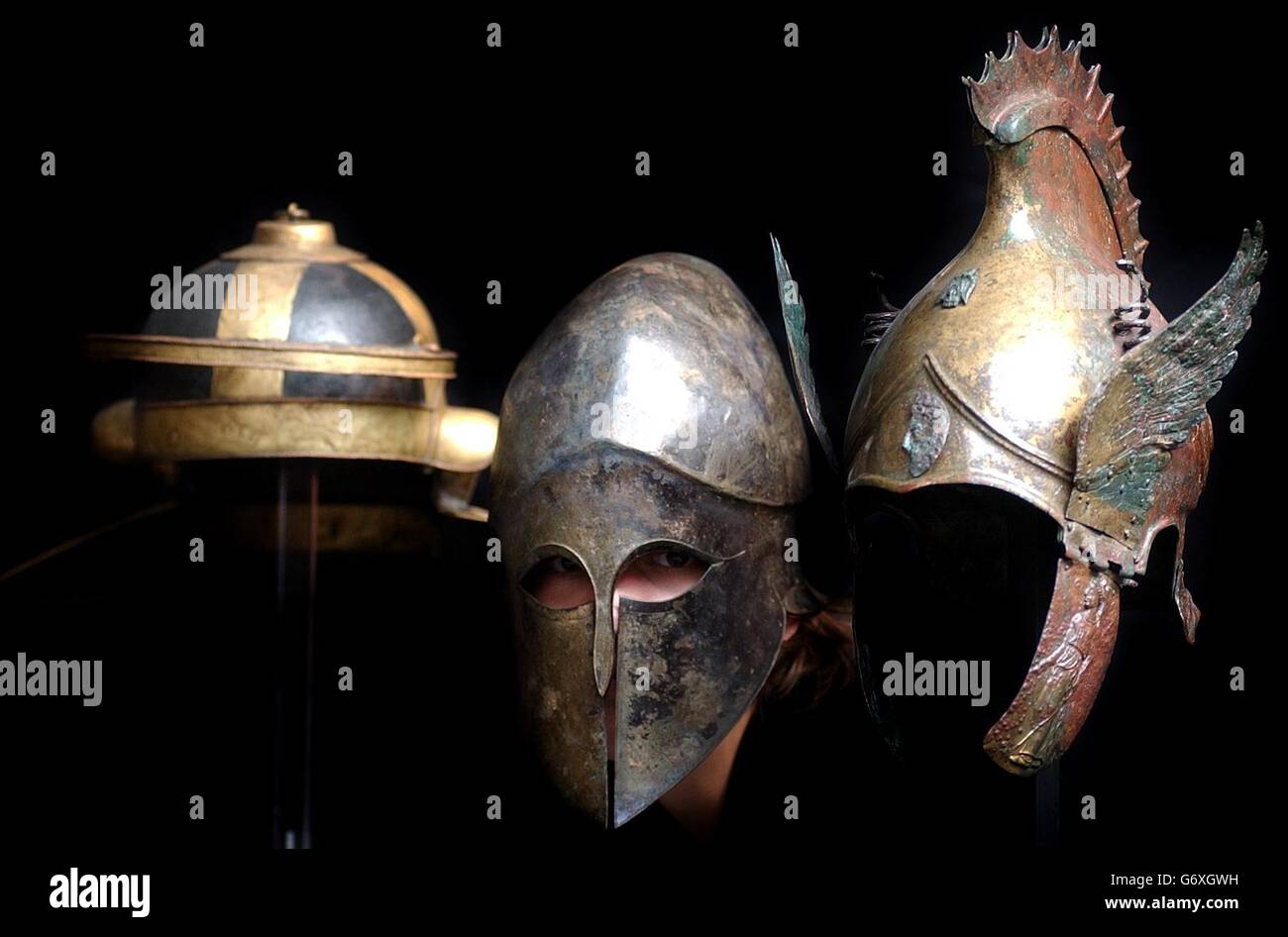 Three helmets that are part of The Axel Guttman Collection of Ancient Arms and Armour Part 2, Tuesday April 27, 2004, (l-r) The Guttmann 'Mouse' Helmet expected to fetch 350,000- 500,000, a Corinthian type bronze helmet expected to fetch 20,000- 30,000 and a Phrygian -Chalcidian type winged bronze helmet expected to fetch 70,000- 90,000, at a sale to be held at Christies, South Kensington. Stock Photo