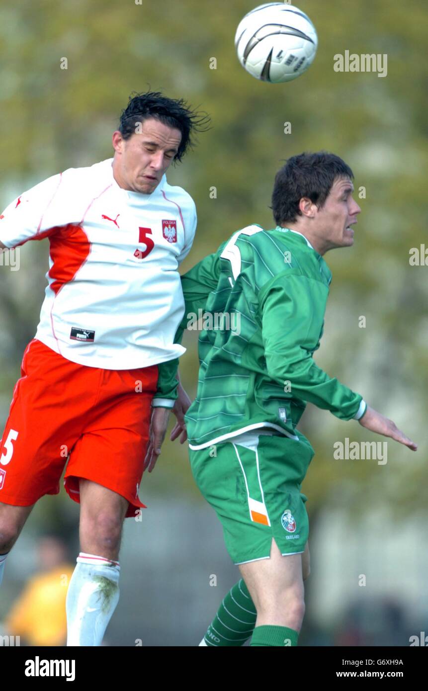 Ireland's Patrick McCarthy (right) and Poland's Dariusz Dudka compete for a high ball, during an International U-21 friendly at Grudziadz-Stadion 'Olimpii'. Stock Photo