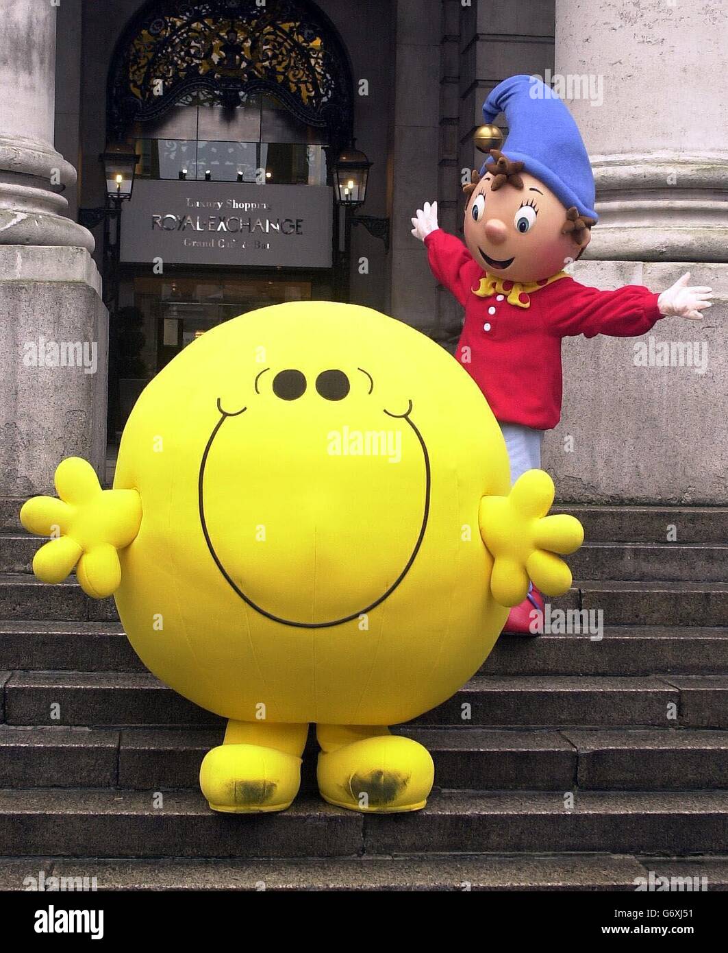 The children's characters Mr Happy (right) and Noddy meet outside the Bank of England in London, after entertainment group Chorion said it was planning to buy the business behind the Mr Men for 28 million. The London-based group who already own the Noddy characters, said it was proposing to acquire The Hargreaves Organisation and Mister Films, which together own the rights to the Mr Men. Stock Photo