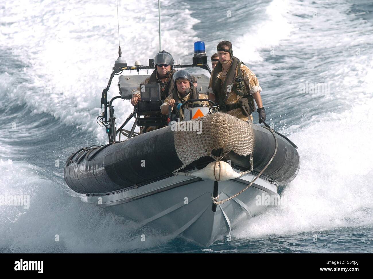 A team of Royal Marines led by 2 Lt Doug Pennefather, 26, (right) attached to HMS Grafton, A Type 23 Frigate currently patrolling the waters off the coast of Iraq. Terrorist activities off the coast of Iraq will not be curbed unless the coalition co-operates more closely with Iran, according to the captain of the British warship patrolling the region. Commander Adrian Cassar said the occupying forces had been making good progress regulating shipping in Iraqi territory, but had little information concerning movements in neighbouring Iranian waters. Stock Photo