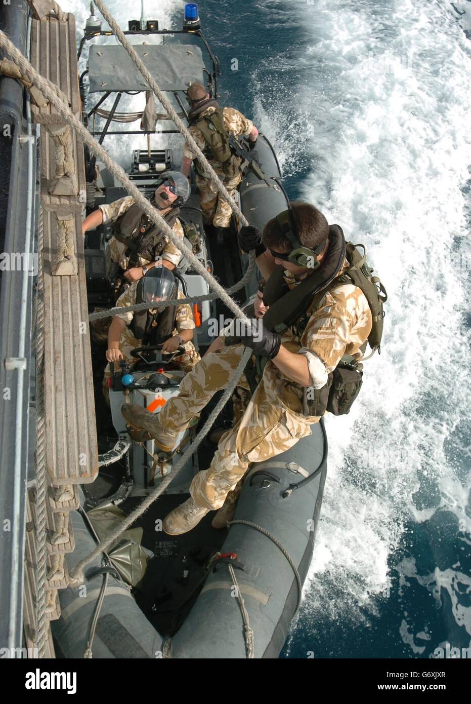 2nd Lt Doug Pennefather, 26, of the Royal Marines slides into a launch attached to HMS Grafton, A Type 23 Frigate currently patrolling the waters off the coast of Iraq. Terrorist activities off the coast of Iraq will not be curbed unless the coalition co-operates more closely with Iran, according to the captain of the British warship patrolling the region. Commander Adrian Cassar said the occupying forces had been making good progress regulating shipping in Iraqi territory, but had little information concerning movements in neighbouring Iranian waters. Stock Photo