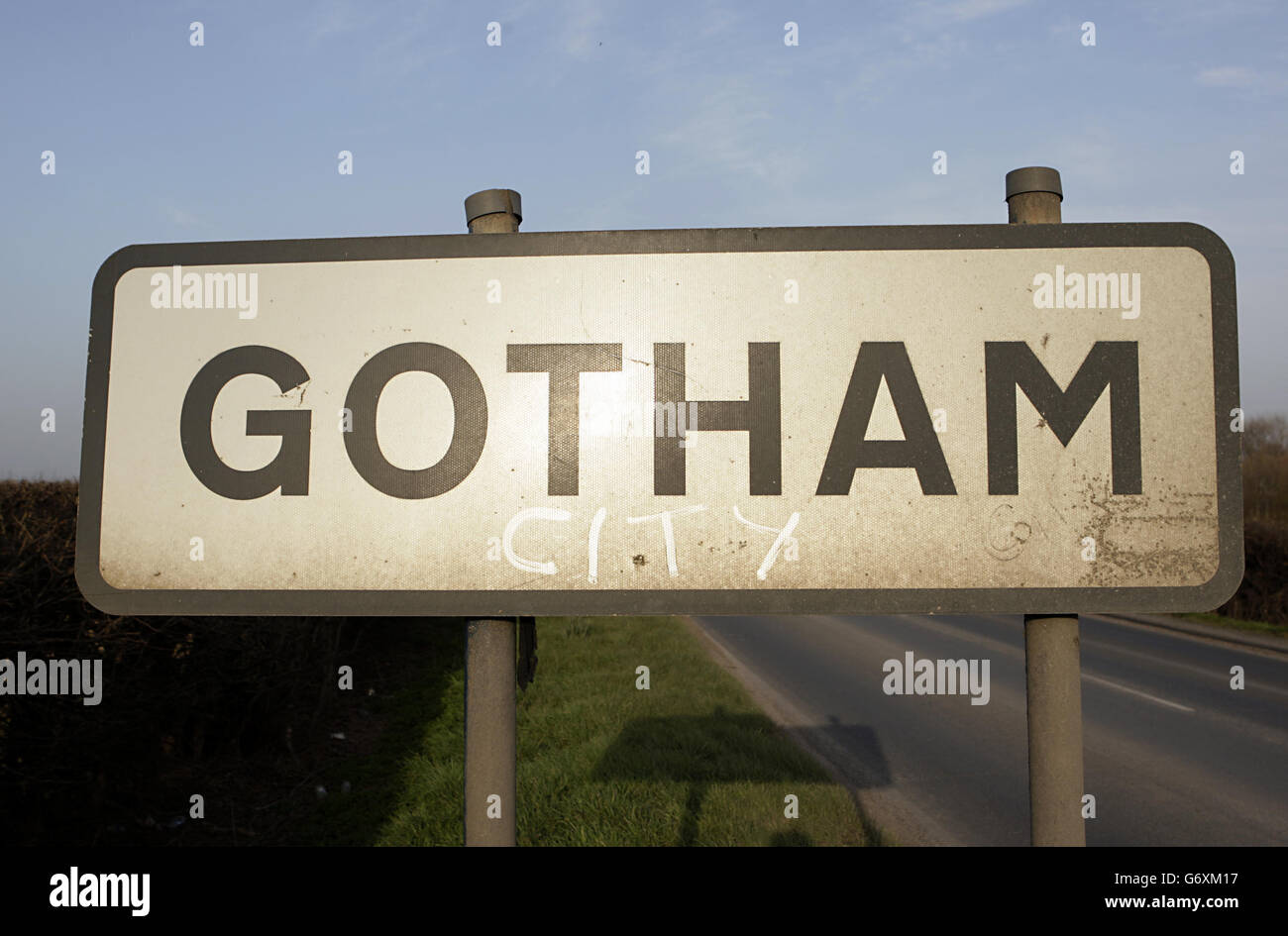 A Gotham Village road sign post, including where someone has written 'City' underneath. Stock Photo