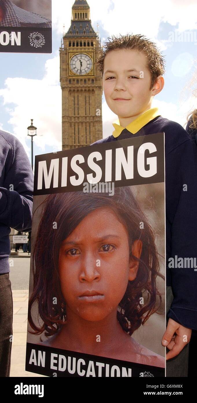 Joe Purnell aged 10, from the Monteclefe Junior School in Somerset, stands outside Parliament in Westminster, London. Thousands of school children from across the UK were urging the Government to take action to help solve the global education crisis. Stock Photo