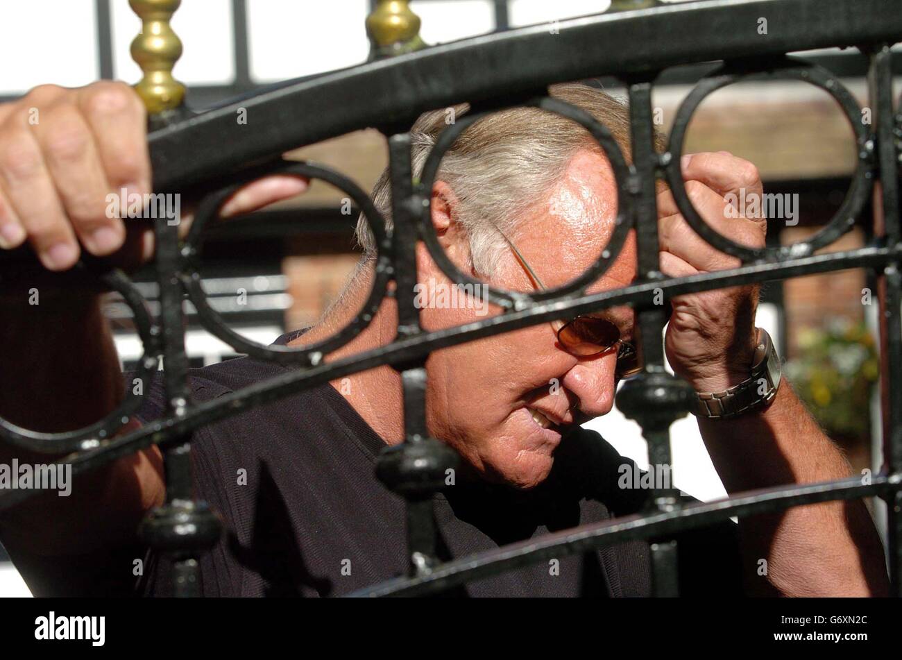 Former Football Pundit Ron Atkinson Looks Through The Gates Of His Home 