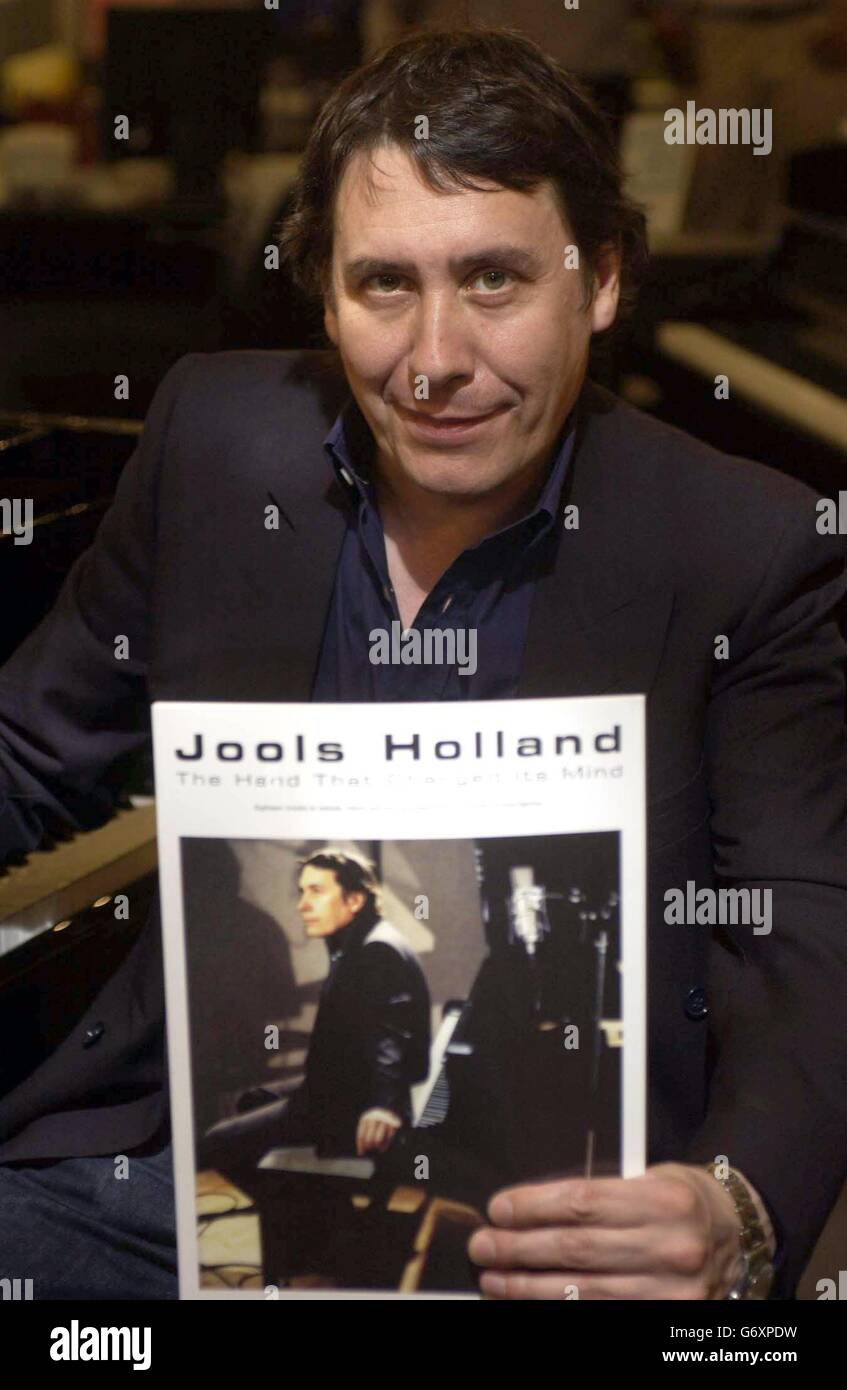 Pianist Jools Holland poses for photogrphers to celebrate the publication of his first ever book of compositions 'The Hand That Changed Its Mind' at Chappells in central London Stock Photo