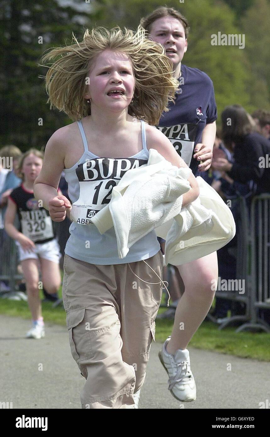 Balmoral Road Races 2004. Balmoral Road Races. Runner checks her finishing time on the BUPA Junior Great Caladonian Run. Stock Photo