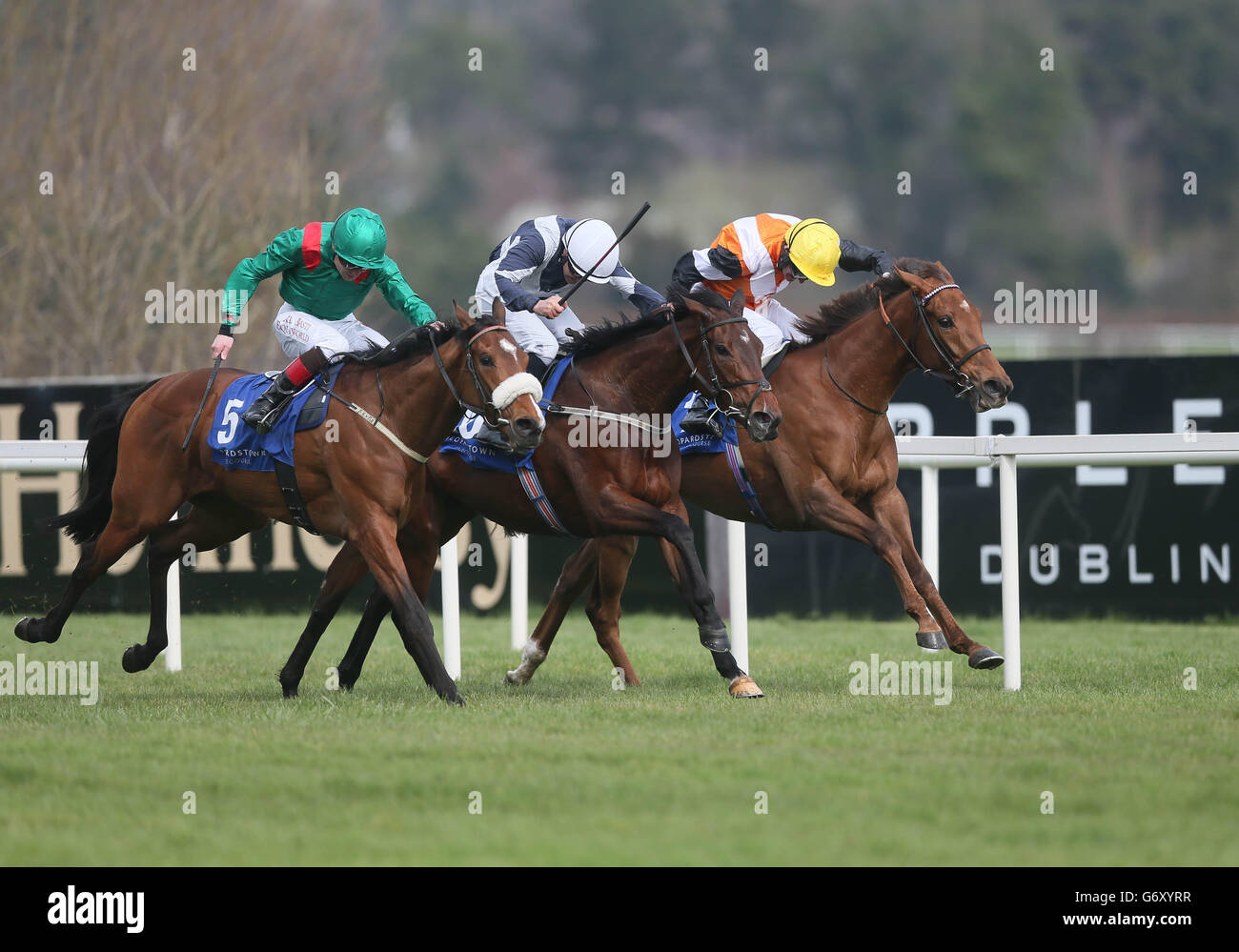 Ceisteach ridden by Kevin Manning (right) in front of Kaleefa ridden by Pat Smullen (left) and Ode To Psyche ridden by N.G. McCullagh (centre), wins The Irish Stallion Farms European Breeders Fund Fillies Maiden during the Guineas Trials day at Leopardtown Racecourse, Dublin, Ireland. PRESS ASSOCIATION Photo. Picture date: Sunday March 30, 2014. See PA Story RACING Leopardstown. Photo credit should read: Artur Widak/PA Wire. Stock Photo