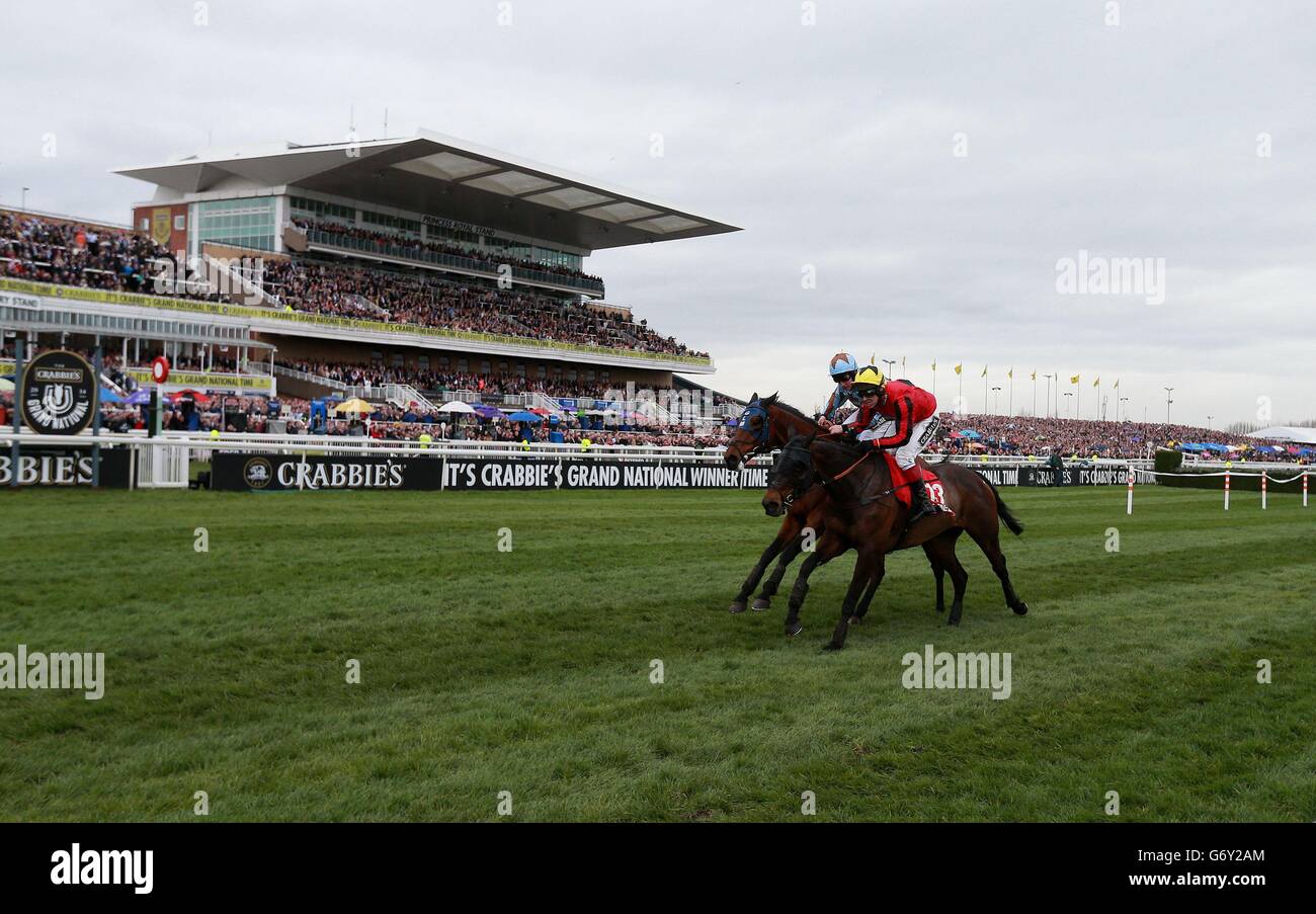 Duke of Lucca (right) ridden by Richard Johnson goes on to win The Betfred TV Handicap Steeple Chase ahead of Vino Griego and jockey Jamie Moore during Grand National Day of the Crabbie's Grand National 2014 Festival at Aintree Racecourse, Liverpool. Stock Photo