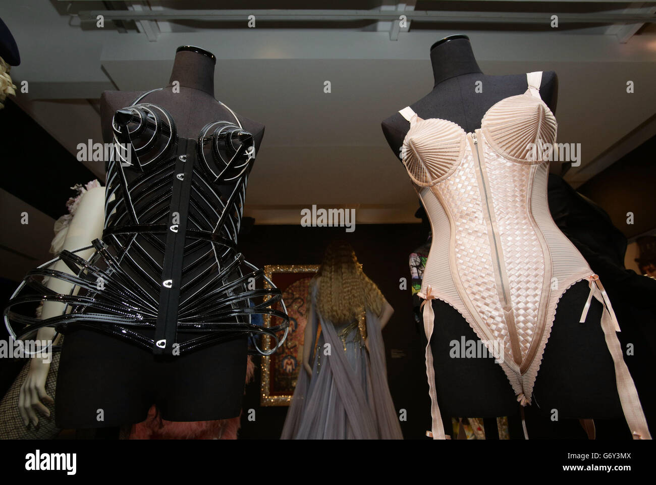 The clothes on display during a media view of 'The Fashion World of Jean Paul Gaultier: From the Sidewalk to the Catwalk' - the first major exhibition devoted to the celebrated French couturier, including costumes for film and performance including the conical bra and corsets Madonna wore during her 1990 Blond Ambition World Tour, stage costumes designed for Kylie Minogue as well as pieces created for the films of Pedro Almodovar among others - at Barbican Art Gallery in London. Stock Photo