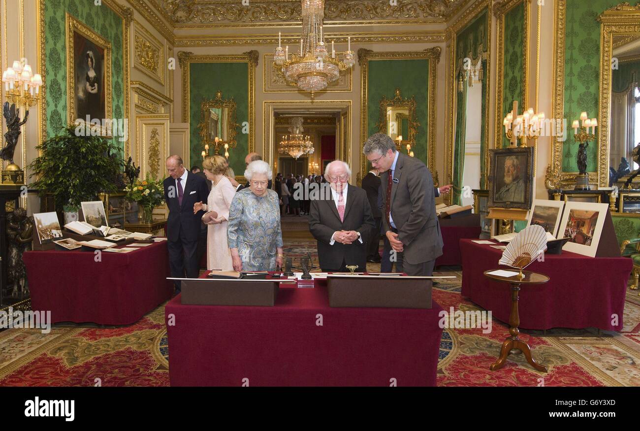 Queen Elizabeth II accompanies Irish President Michael D Higgins (2nd right) as he is shown Irish related items from the Royal Collection, in the Green Drawing Room, in Windsor Castle, during the first State visit to the UK by an Irish President. Stock Photo